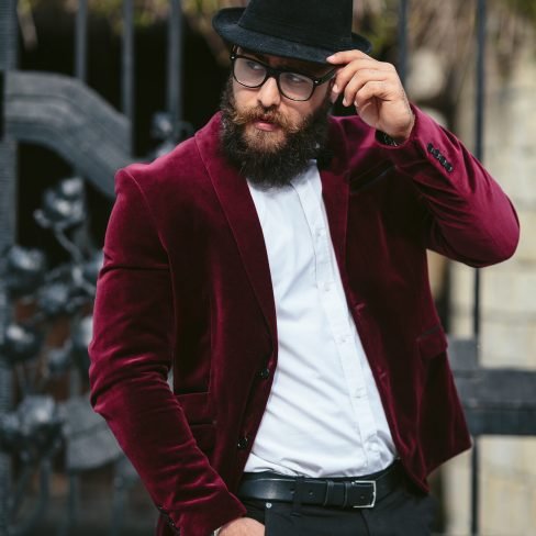a rich man in a jacket near his house
